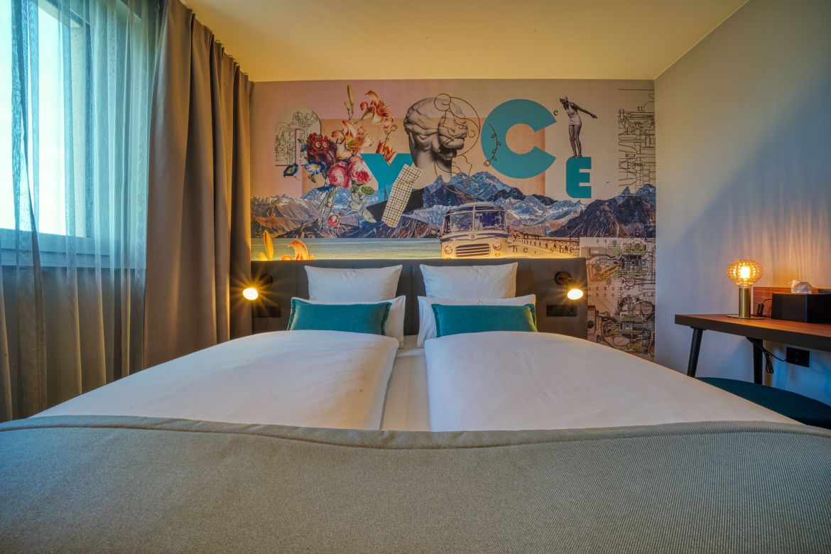 double bed, colorful wall, lamps, window, curtains